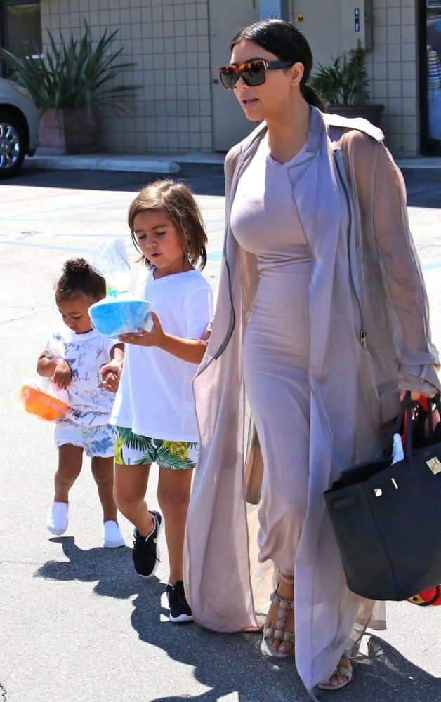 Pregnant- Kim -Kardashian -heads -to -a -birthday- party -with- daughter North- and- niece- Penelope- Disick