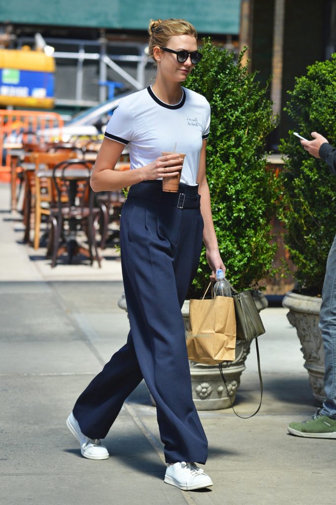 Karlie Kloss wears a high waisted pair of pants as she takes a walk in SoHo