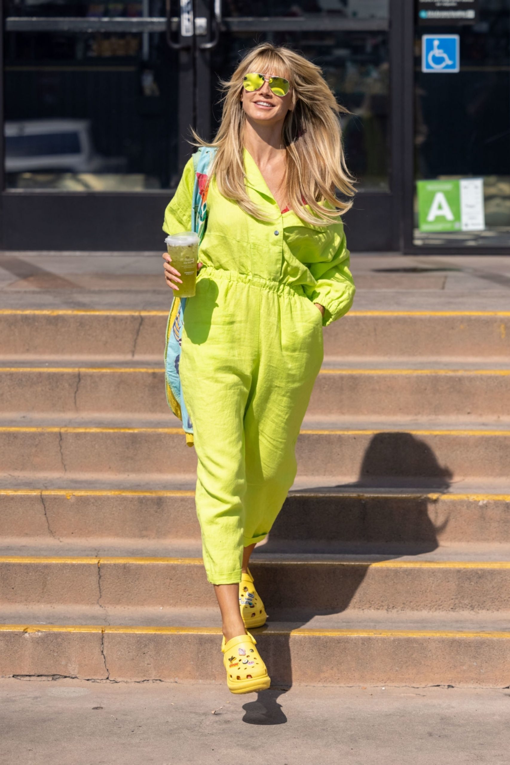 Heidi Klum Wears Yellow Jumpsuit & Crocs Out In Los Angeles