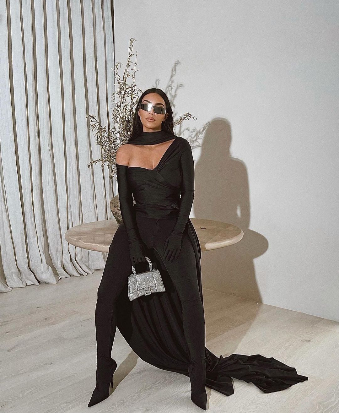 kim-kardashian-west-wears-balenciaga-outfit-with-a-cape-and-sparkly-handbag