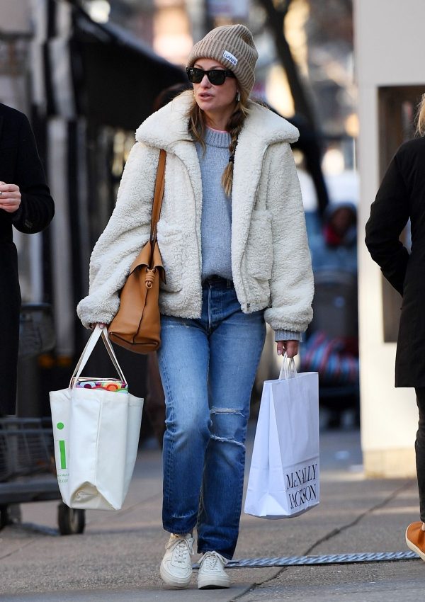 Olivia Wilde in white teddy jacket & jeans in NYC on March 20, 2023