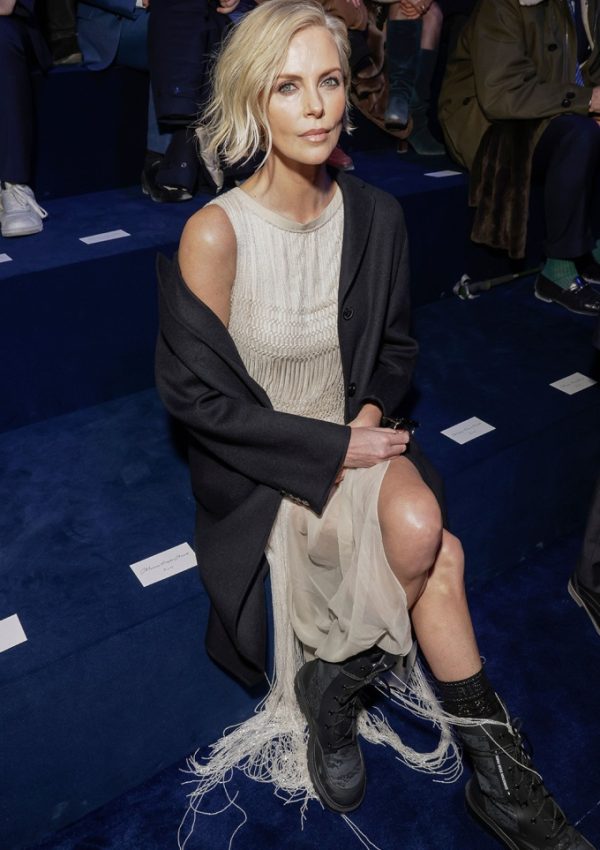 Charlize Theron in Fringe dress with  combat boots  front row at Christian Dior Fall 2023