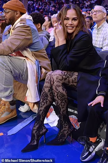 Chrissy Teigen wore  Alessandra Rich Cut-Out Lace Jumpsuit @  Knicks Game December 25, 2023